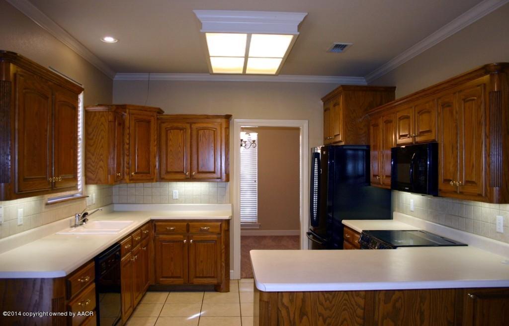 5827 Nicholas Circle Amarillo, TX 79109 - Photo 4 of 23 a kitchen with stainless steel appliances kitchen island granite countertop a sink and cabinets