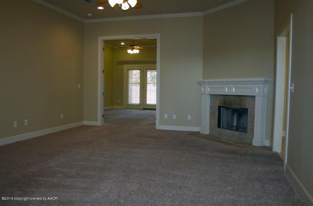 5827 Nicholas Circle Amarillo, TX 79109 - Photo 8 of 23 an empty room with a fireplace and fan