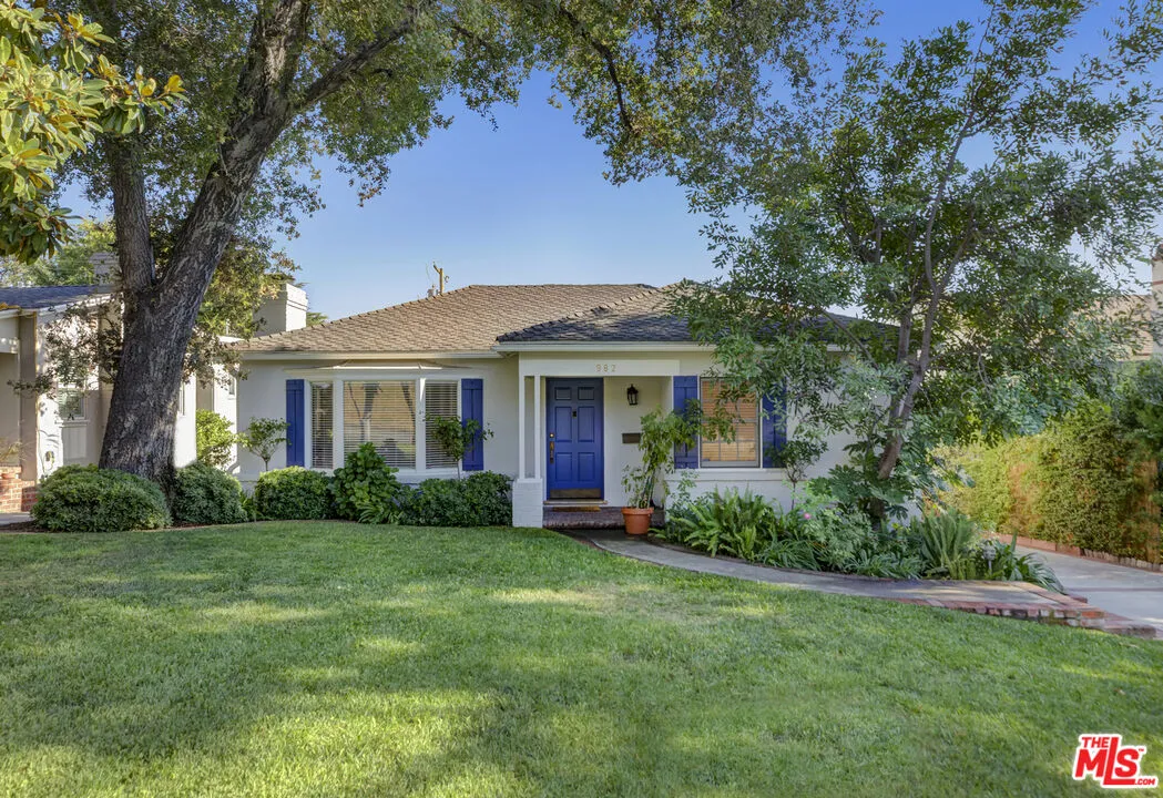 a view of a house with garden and yard