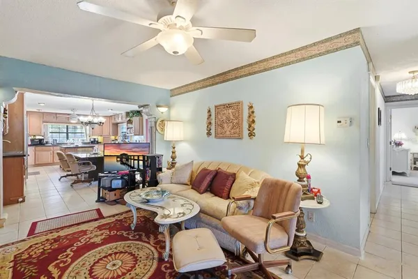 a living room with furniture and a lamp