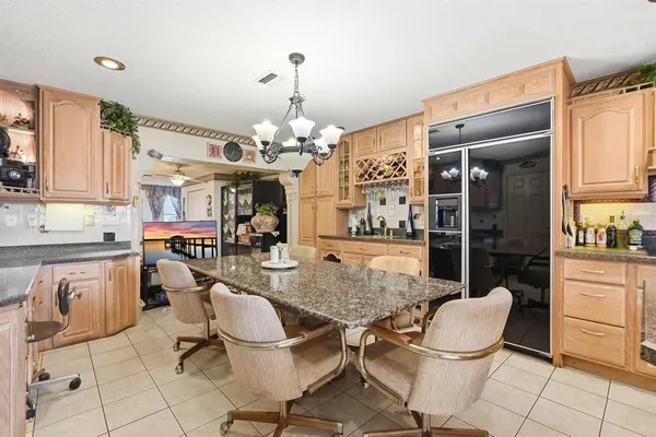 a kitchen with stainless steel appliances granite countertop a stove and cabinets