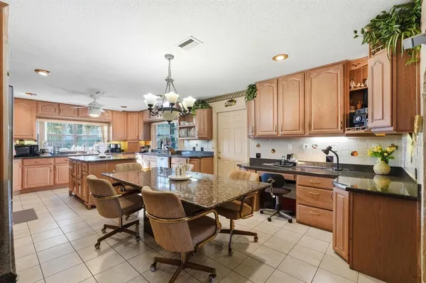 a kitchen with stainless steel appliances granite countertop a sink and cabinets