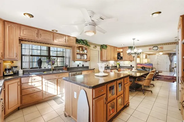 a kitchen with stainless steel appliances granite countertop a sink and cabinets