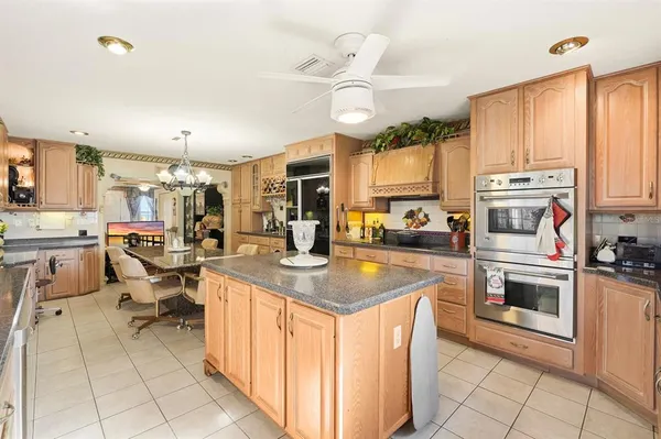 a kitchen with stainless steel appliances granite countertop a sink and cabinets