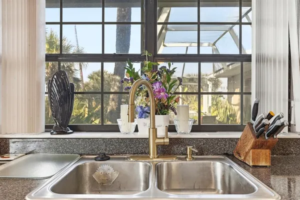 a kitchen with stainless steel appliances granite countertop a sink and cabinets