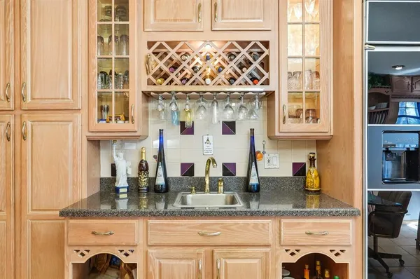 a kitchen with stainless steel appliances granite countertop a sink a stove counter space and cabinets