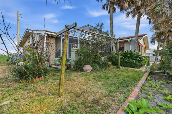 a view of a house with a yard and many windows