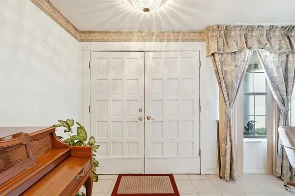 a bed room with a bed and a chandelier