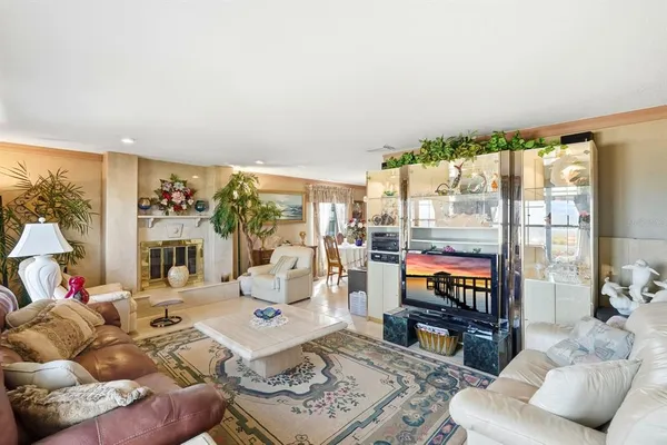 a living room with furniture large window and a flat screen tv
