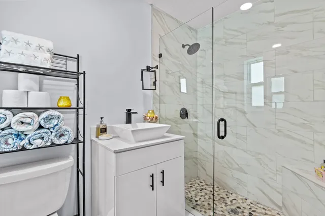 a bathroom with a sink toilet and shower