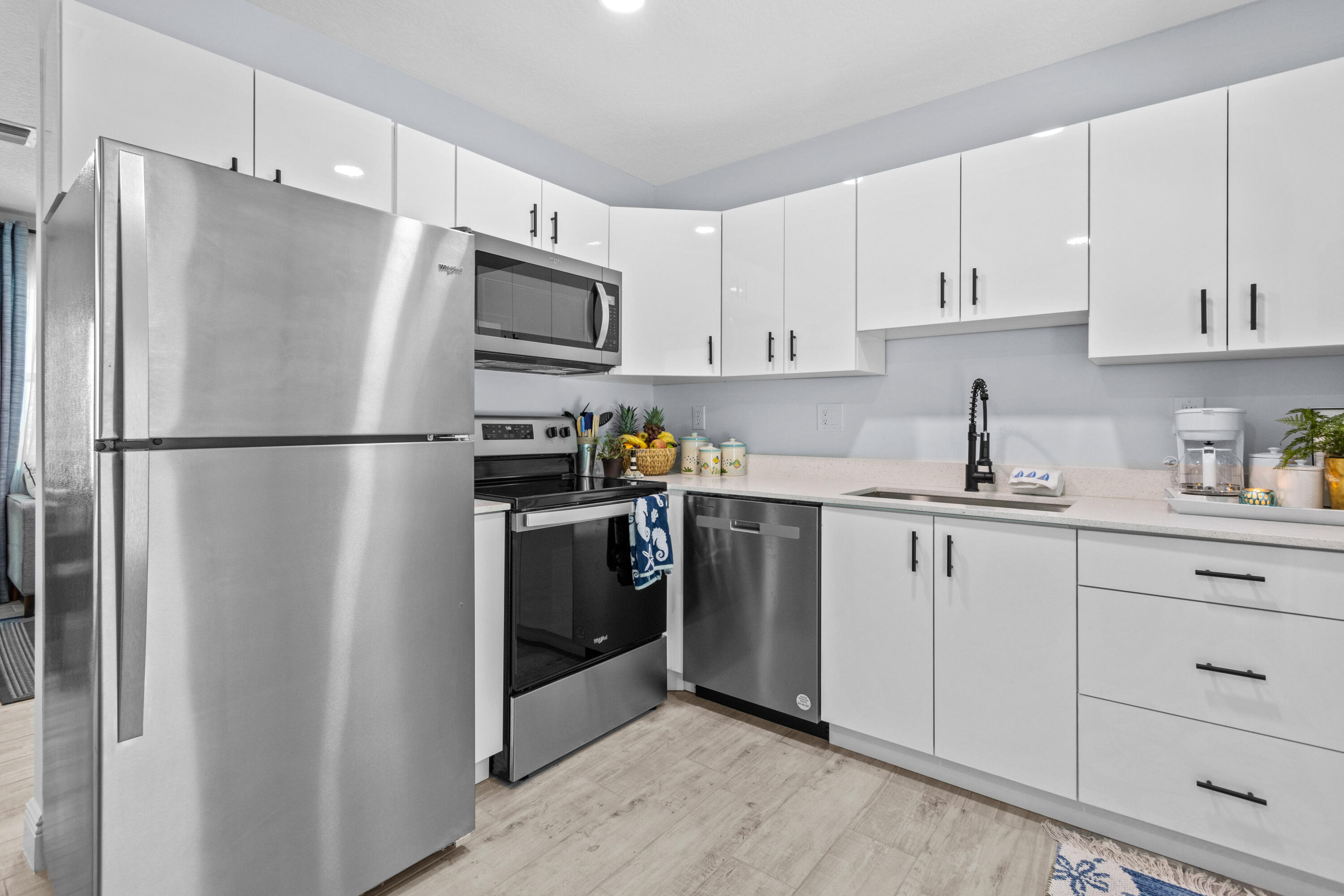 711 South Ocean Drive, Unit B Fort Pierce, FL 34949 - Photo 7 of 21 a kitchen with cabinets stainless steel appliances and refrigerator