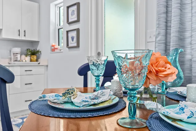 a dining room with furniture and a wooden floor