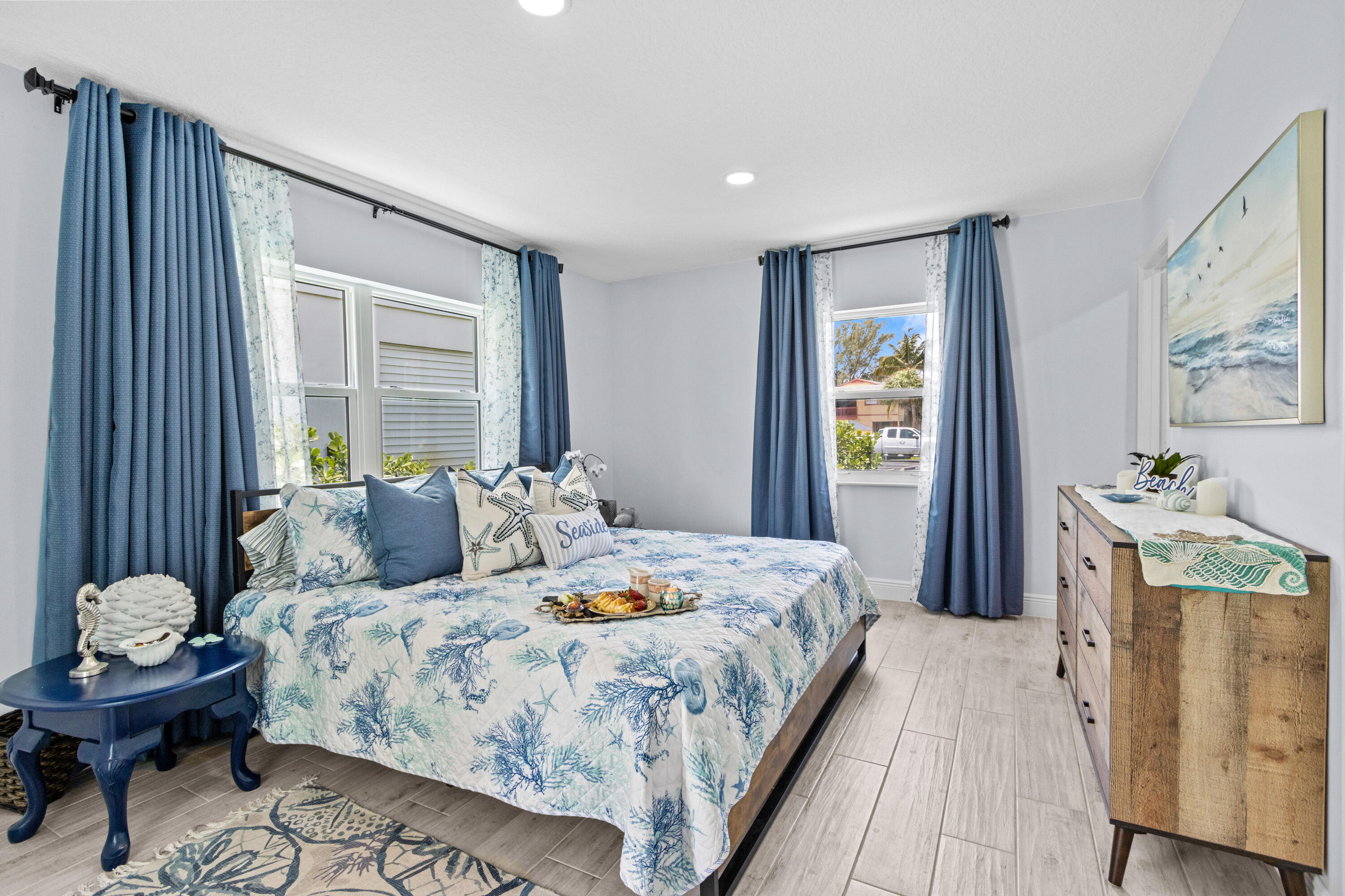 711 South Ocean Drive, Unit B Fort Pierce, FL 34949 - Photo 9 of 21 a bedroom with a bed and large windows