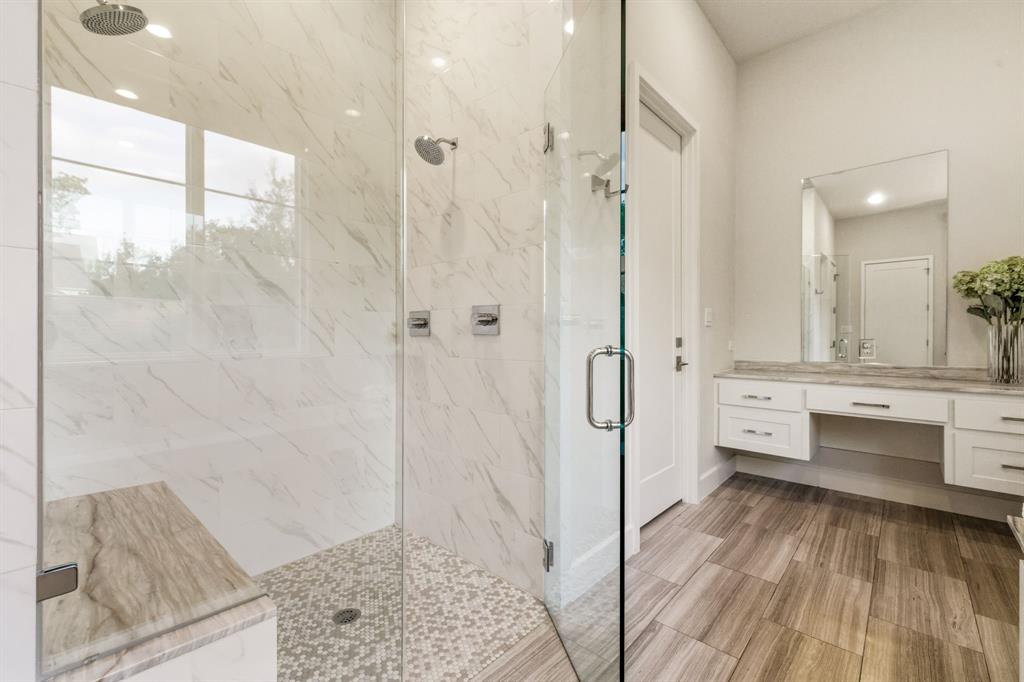 6523 Northwood Road Dallas, TX 75225 - Photo 21 of 36 a bathroom with a sink a toilet and shower