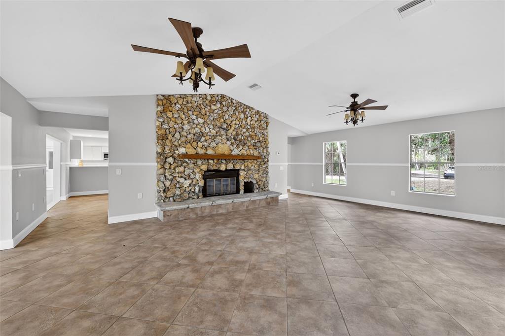 4570 Hidden River Road Sarasota, FL 34240 - Photo 16 of 45 an empty room with windows and fireplace