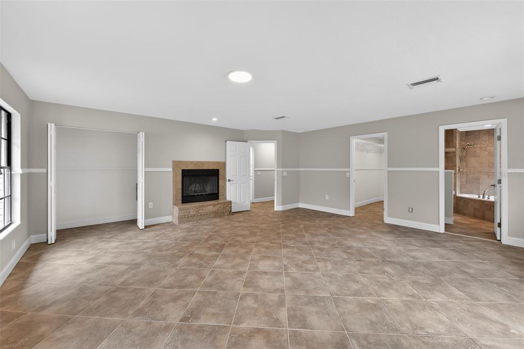 4570 Hidden River Road Sarasota, FL 34240 - Photo 20 of 45 a view of an empty room with a fireplace