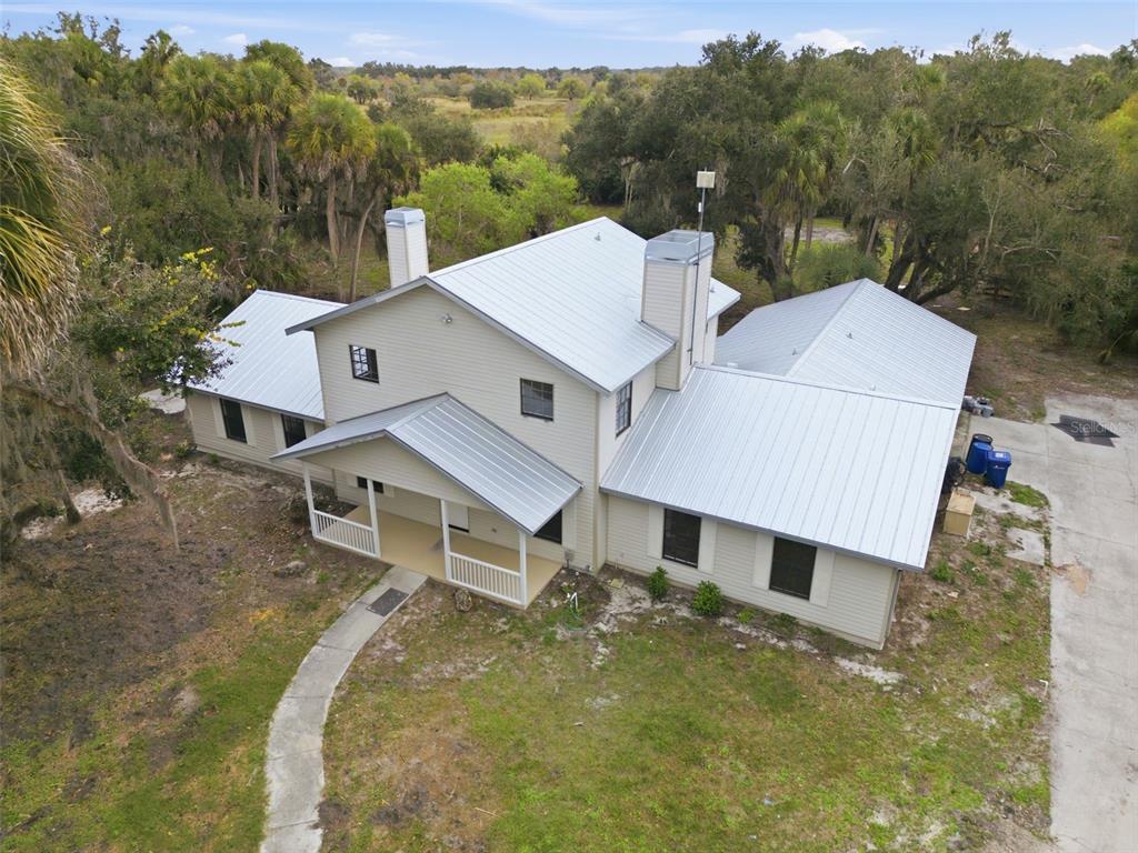 4570 Hidden River Road Sarasota, FL 34240 - Photo 2 of 45 an aerial view of a house with a yard and balcony
