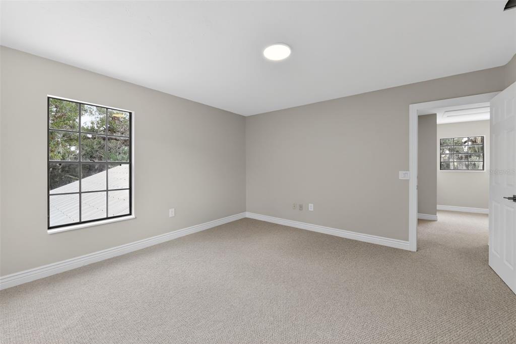 4570 Hidden River Road Sarasota, FL 34240 - Photo 22 of 45 an empty room with windows