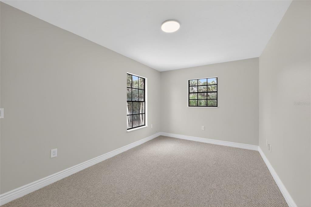 4570 Hidden River Road Sarasota, FL 34240 - Photo 25 of 45 an empty room with a window