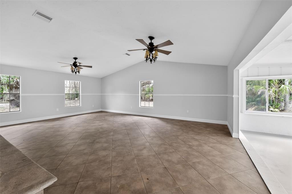4570 Hidden River Road Sarasota, FL 34240 - Photo 27 of 45 an empty room with windows and ceiling fan