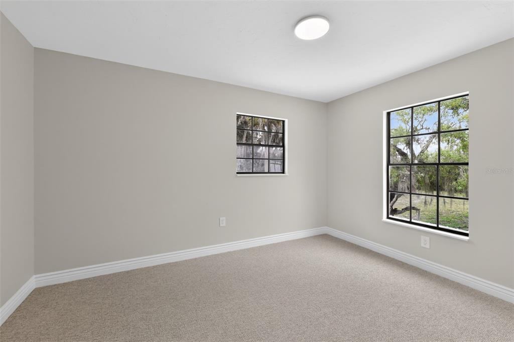 4570 Hidden River Road Sarasota, FL 34240 - Photo 29 of 45 an empty room with windows