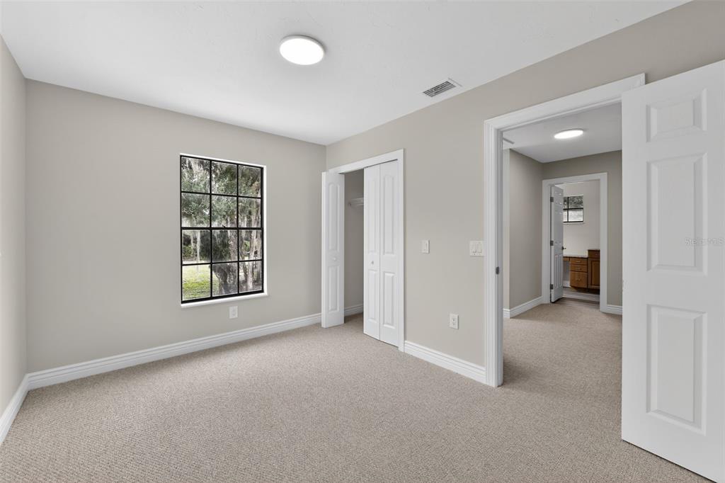 4570 Hidden River Road Sarasota, FL 34240 - Photo 33 of 45 an empty room with windows and bathroom