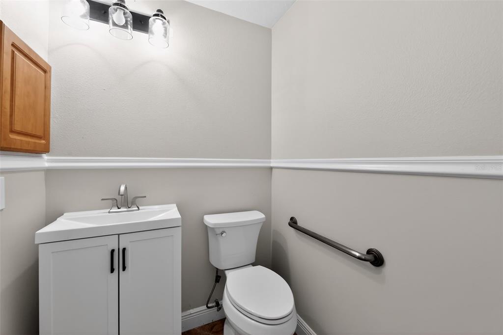 4570 Hidden River Road Sarasota, FL 34240 - Photo 36 of 45 a bathroom with a sink mirror vanity and toilet