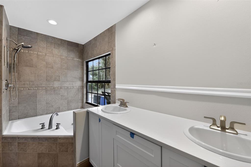 4570 Hidden River Road Sarasota, FL 34240 - Photo 37 of 45 a bathroom with a sink and a bathtub