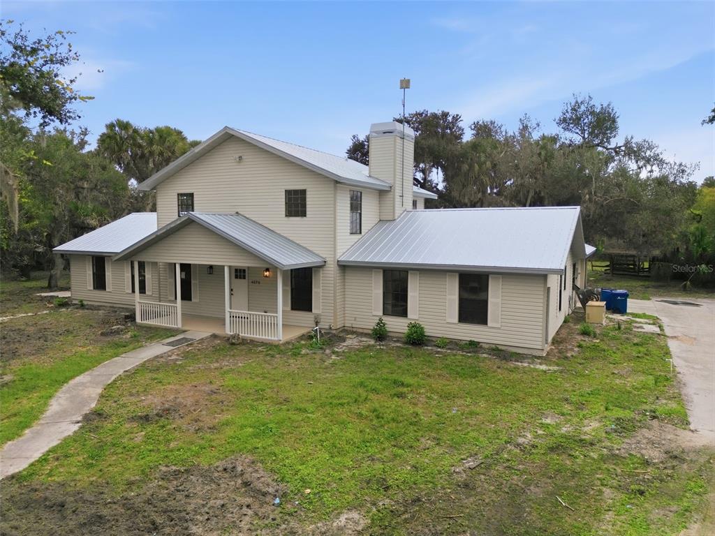 4570 Hidden River Road Sarasota, FL 34240 - Photo 4 of 45 a front view of a house with garden