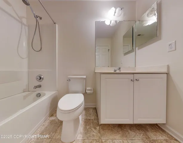 a bathroom with a toilet a sink and a shower