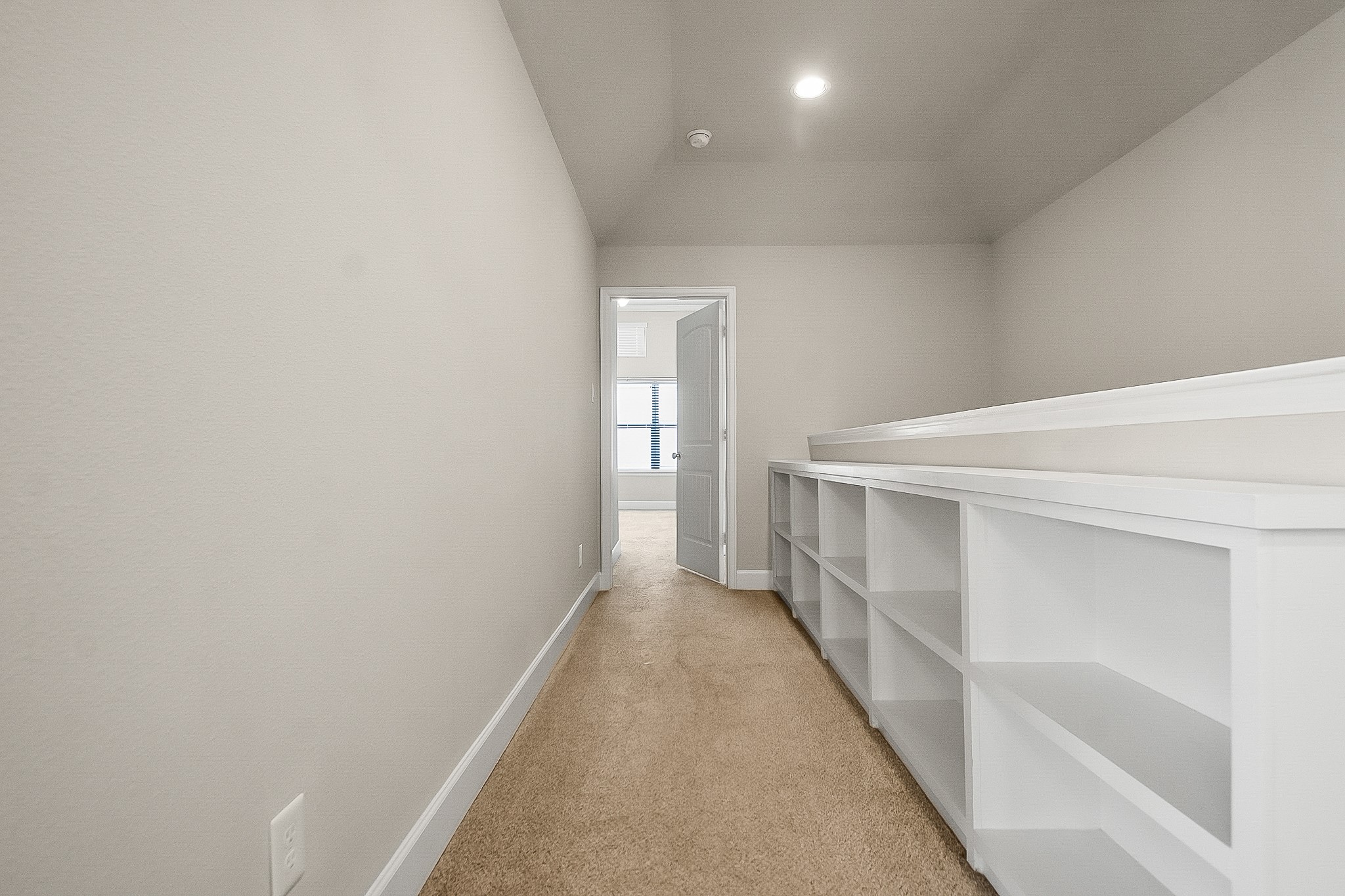 5328 Larkin Street Houston, TX 77007 - Photo 21 of 27 Hallway connecting the game room to the primary suite, thoughtfully designed with built-in storage for added convenience and functionality.