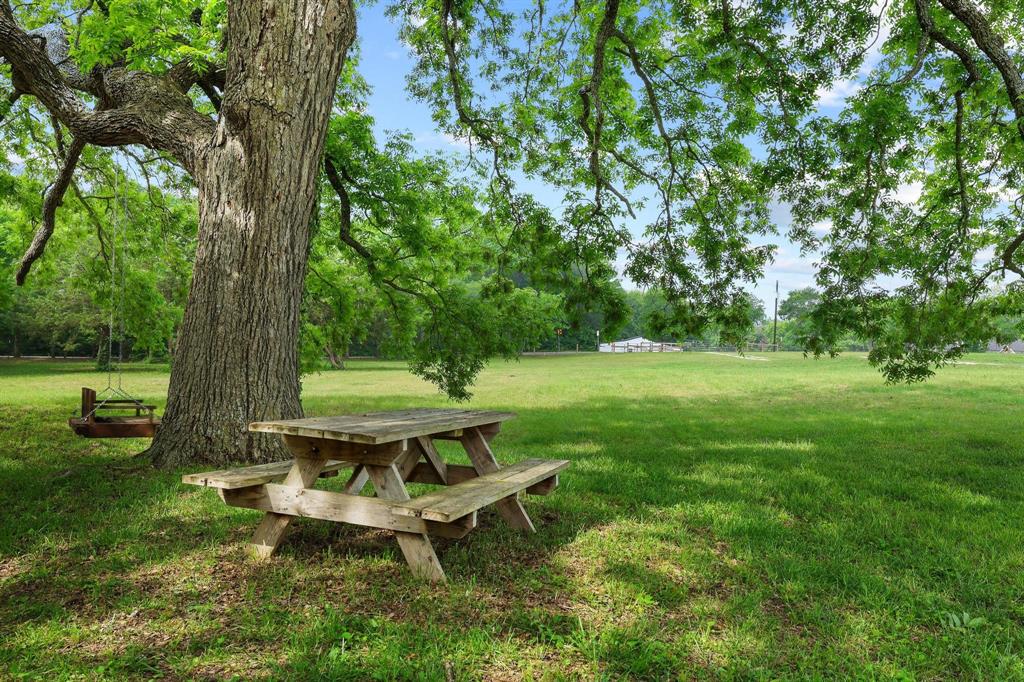 1906 Durning Road Van Alstyne, TX 75495 - Photo 21 of 40 a view of a backyard with a bench and a tree