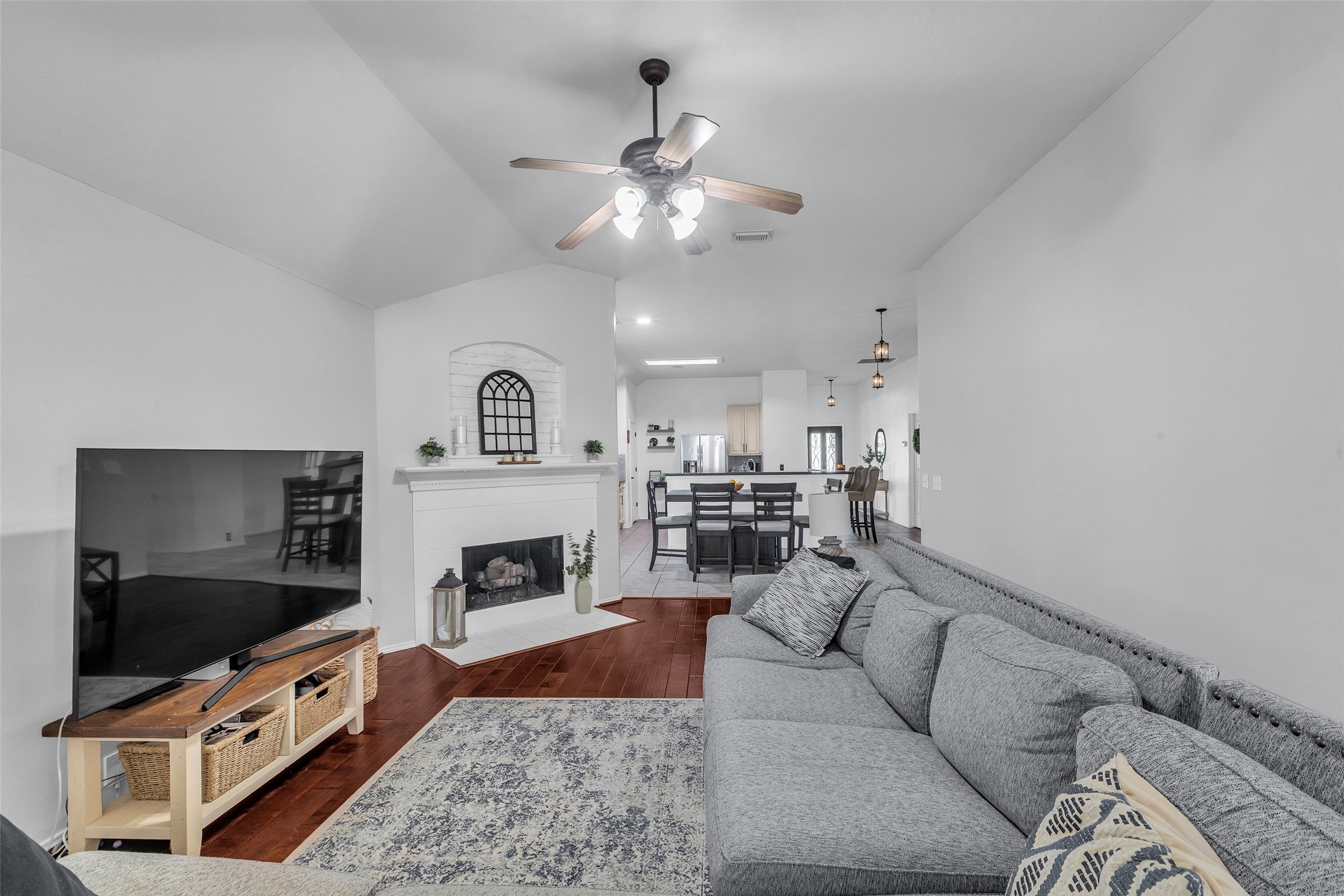 a living room with furniture a fireplace and a flat screen tv