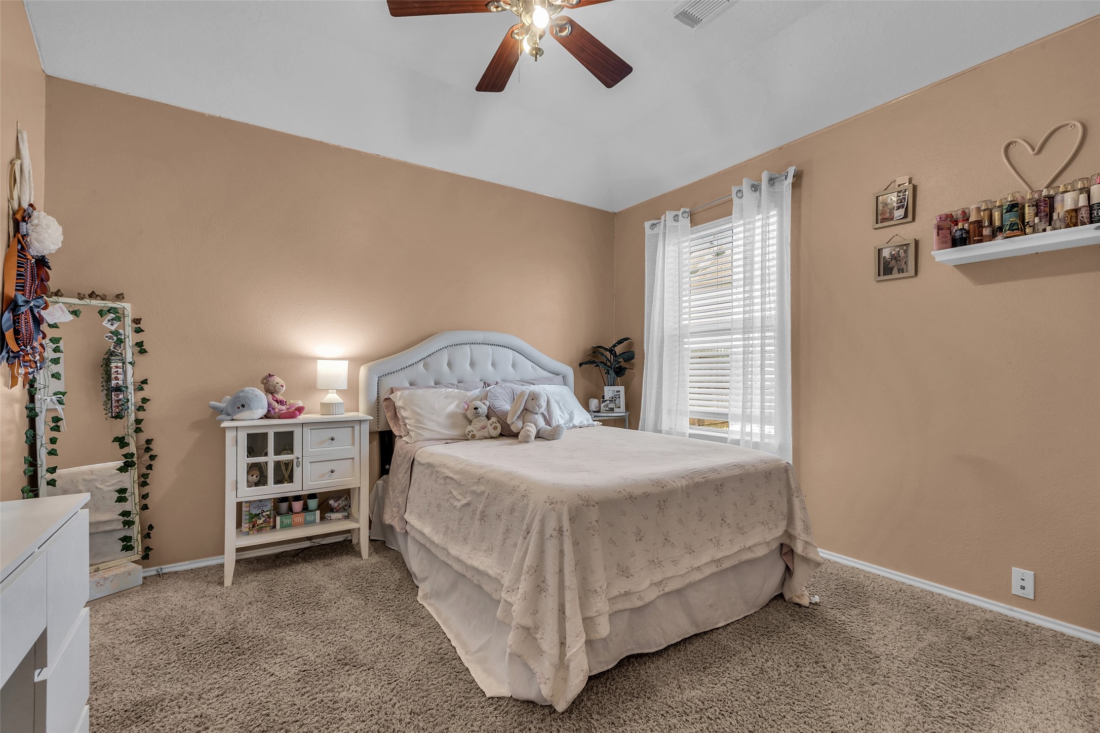 30303 Castle Forest Drive Spring, TX 77386 - Photo 19 of 41 a bedroom with a bed and a chandelier