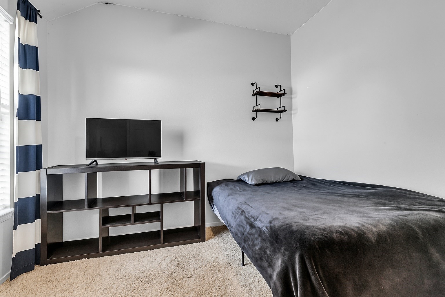 30303 Castle Forest Drive Spring, TX 77386 - Photo 21 of 41 a bedroom with a bed and a flat screen tv