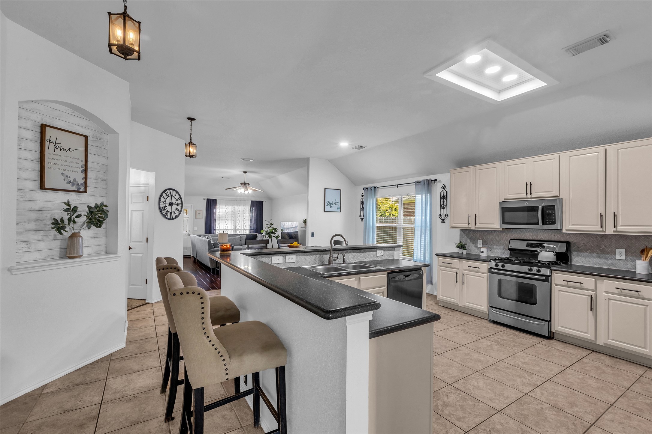 30303 Castle Forest Drive Spring, TX 77386 - Photo 8 of 41 a kitchen with stainless steel appliances granite countertop a stove top oven a sink dishwasher a dining table and chairs with wooden floor
