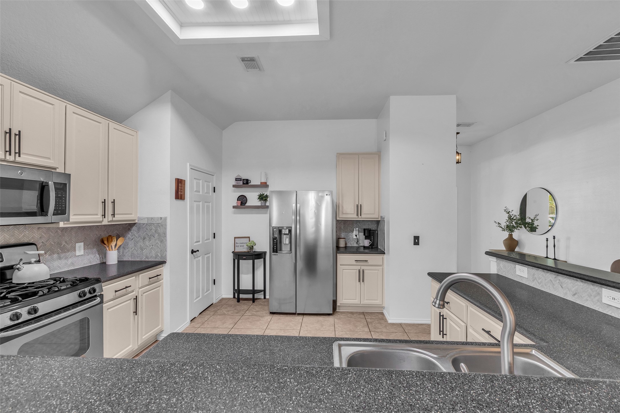 30303 Castle Forest Drive Spring, TX 77386 - Photo 10 of 41 a kitchen with stainless steel appliances granite countertop a sink stove and refrigerator