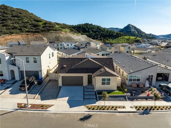 a aerial view of a house with a mountain