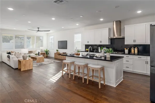 a kitchen with white cabinets and refrigerator