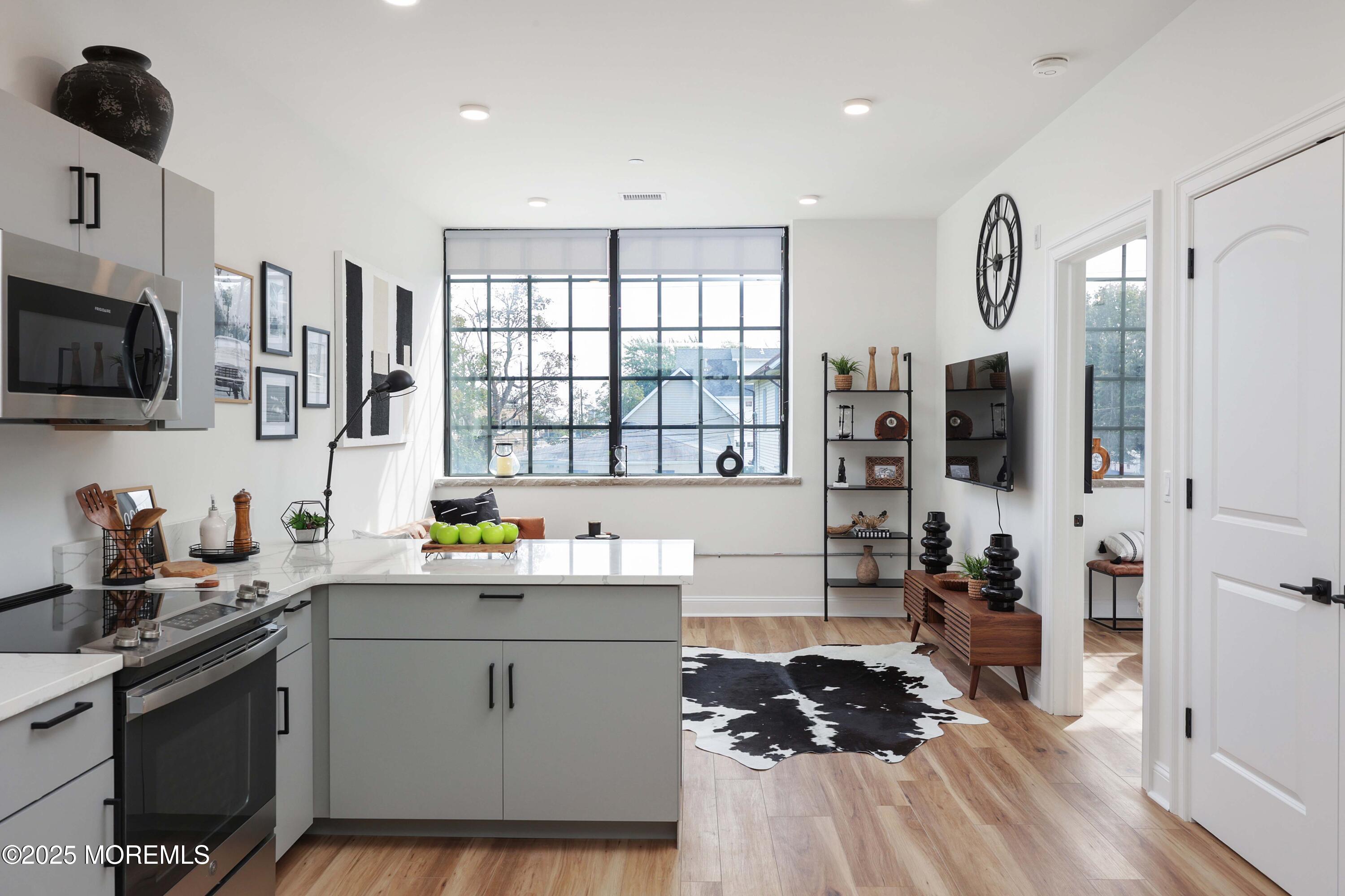 a kitchen with stainless steel appliances a sink stove and cabinets