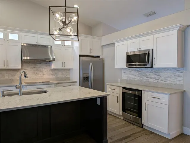 a kitchen with stainless steel appliances a sink stove and refrigerator