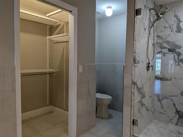 a bathroom with a granite countertop shower