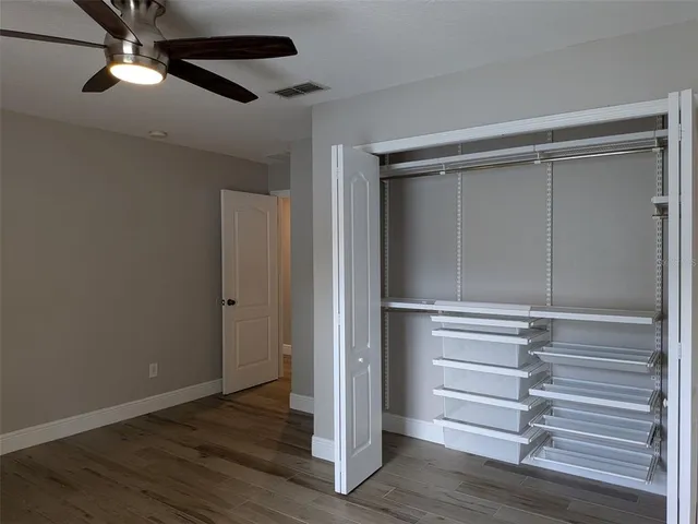 a view of walk in closet with empty racks