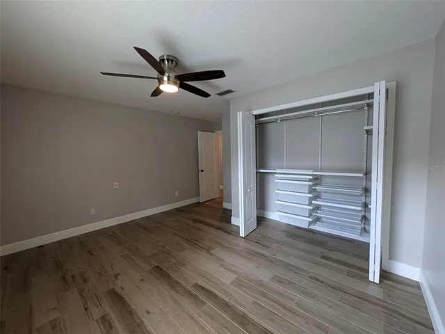 a view of an empty room with wooden floor