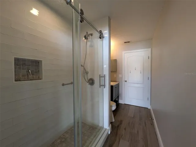 a bathroom with a shower and a toilet