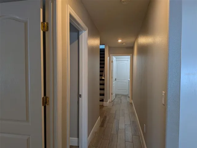 a view of hallway with wooden floor