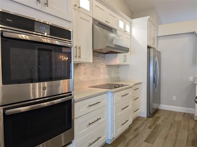 a kitchen with stainless steel appliances and cabinets