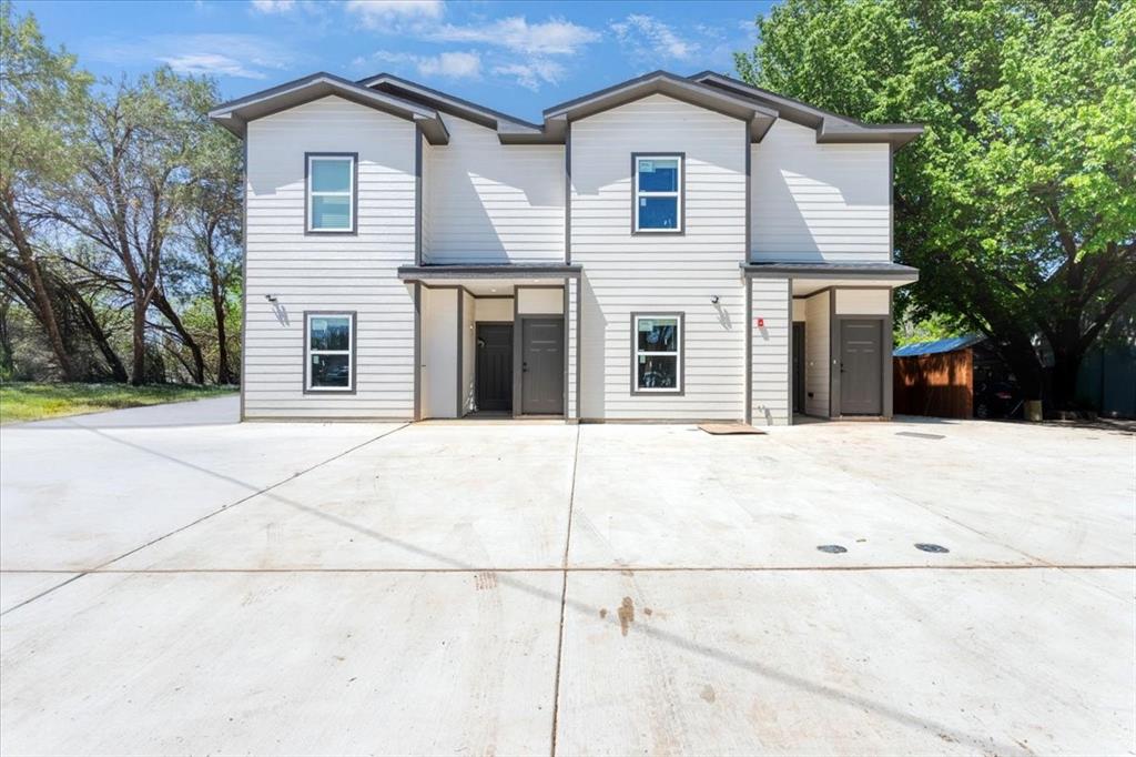 a view of a white house with large windows
