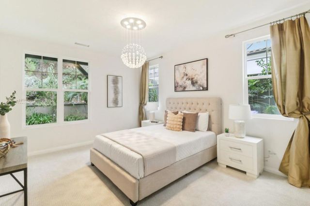 a bedroom with a bed and a large window