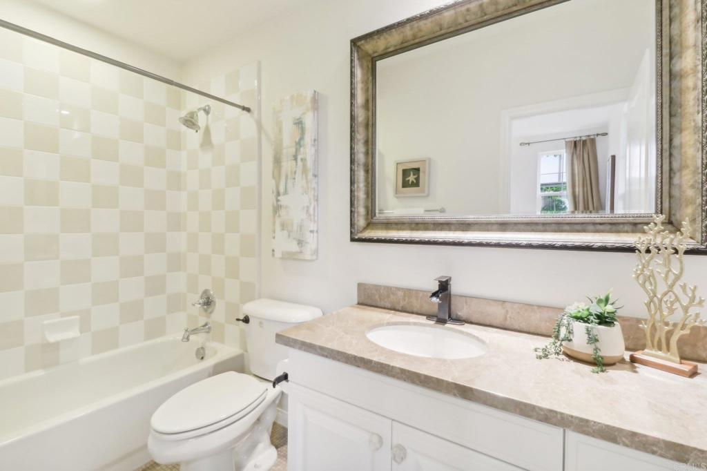 7618 Circulo Sequoia Carlsbad, CA 92009 - Photo 16 of 45 a bathroom with a sink toilet a mirror and shower